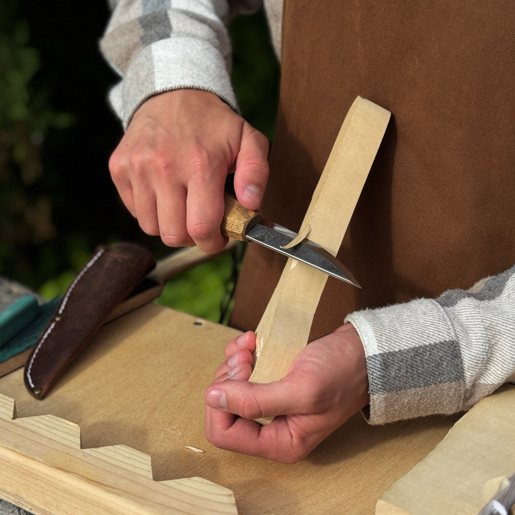 Whittling Sloyd Knife with Leather Sheath being used on wood - Sharky Forged Steel Tools | Relic & Reel