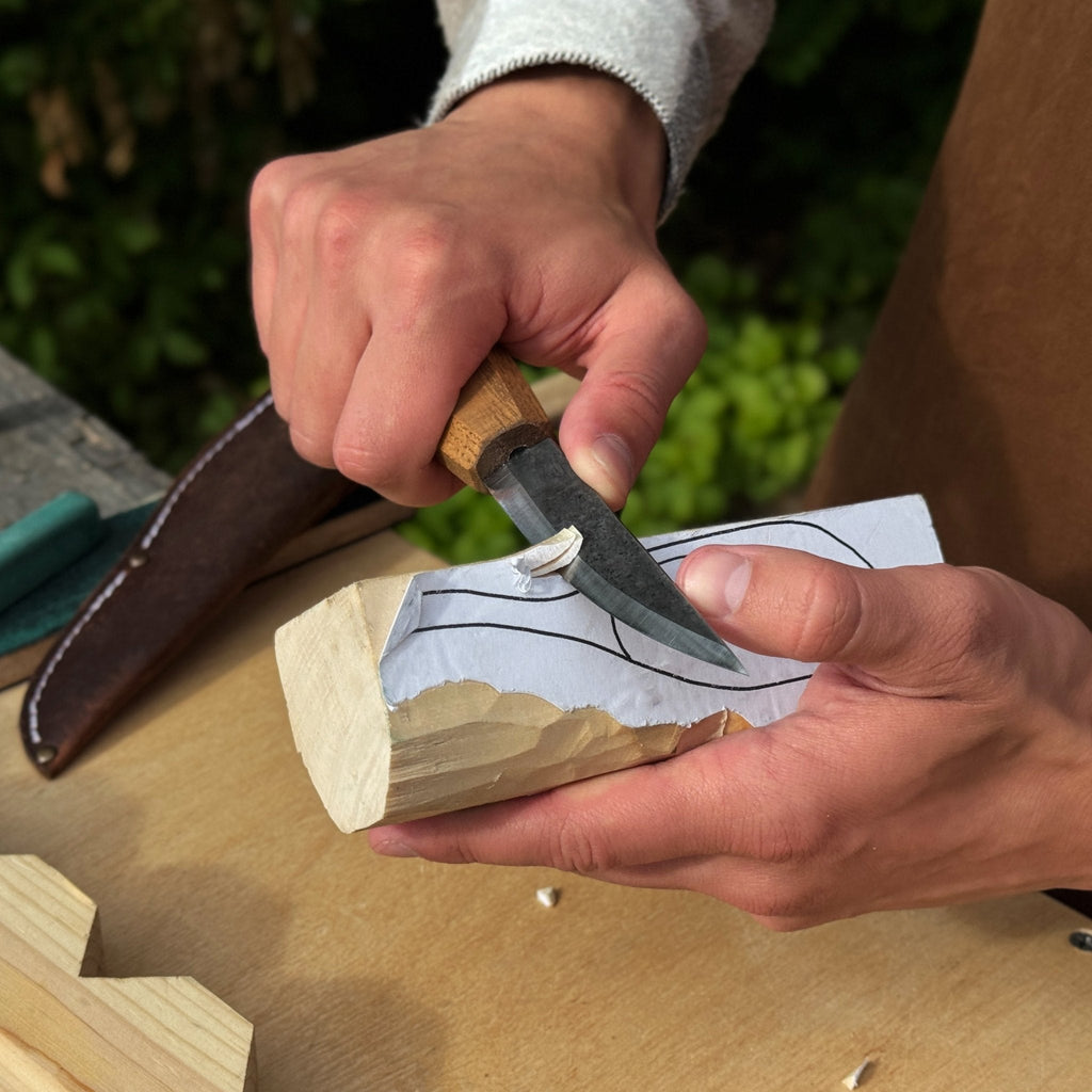 Whittling Sloyd Knife with wooden handle being used on wood | Sharky Forged Steel Tools - Relic & Reel