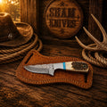 Cowboy belt knife by SHAM KNIVES with 3.25-inch raindrop Damascus blade, antler handle, and turquoise accents.