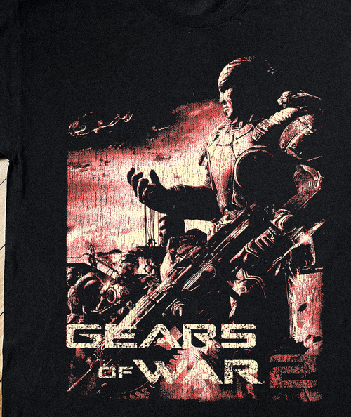Close-up of Parallel Gears of War 2 Xbox 360 black T-shirt featuring bold gear graphics and game logo design.