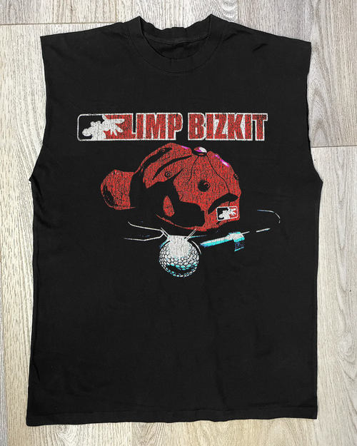 Black Limp Bizkit cut-off shirt by Parallel with raw hem and band logo, casual streetwear style, shown on a hanger.