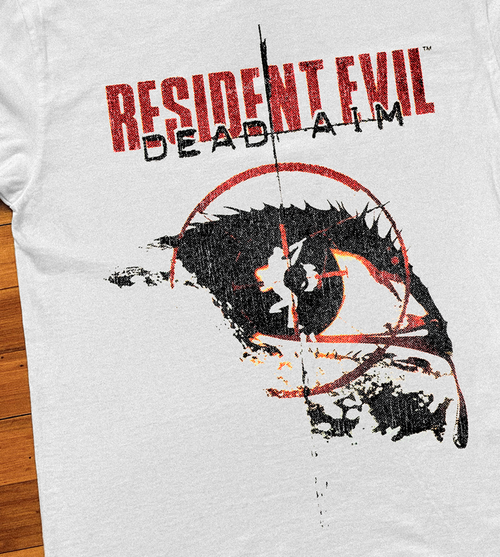 Close-up of a white Resident Evil Dead Aim T-Shirt by Parallel, featuring detailed graphic design on the front.